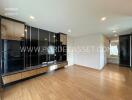 Spacious living room with wooden flooring and built-in storage