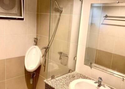 Modern bathroom with urinal, sink, and shower