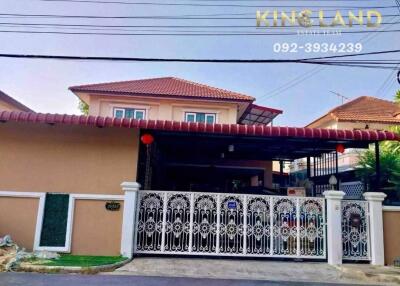 Two-story residential house with gated driveway