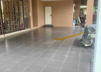 Spacious covered garage area with tiled flooring