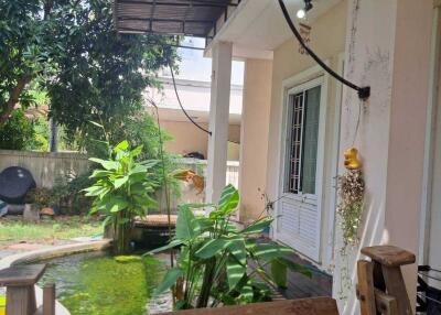 Outdoor sitting area with a view of a garden and fish pond