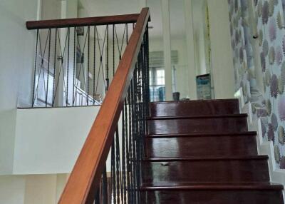 Interior staircase with dark wooden steps and modern railing