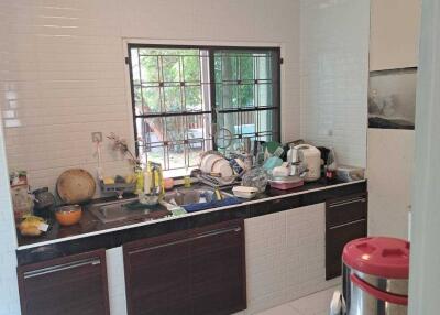 A kitchen with a window, sink, and various appliances