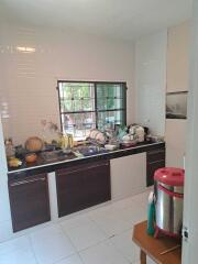 A kitchen with a window, sink, and various appliances