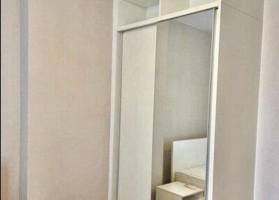 Bedroom with mirrored sliding door wardrobe