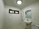 Spacious modern bathroom with white tile walls and fixtures