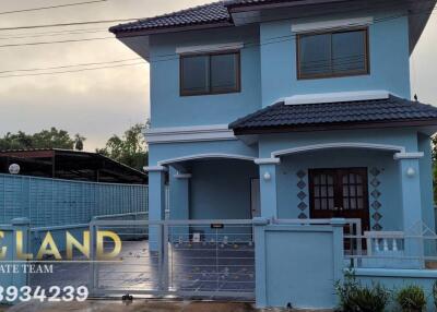 Two-story blue house with a fenced yard