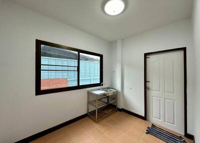 Utility room with a sink and window