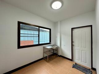 Utility room with a sink and window