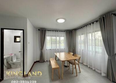 Dining area with large windows and wooden table set