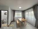 Dining area with large windows and wooden table set