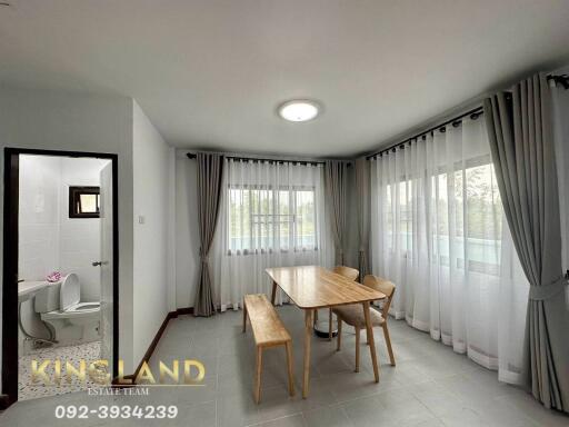 Dining area with large windows and wooden table set