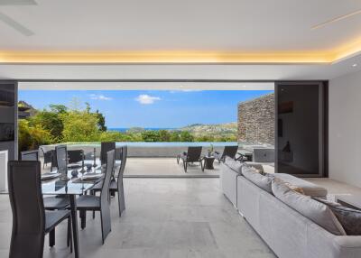 Modern living room and dining area with expansive outdoor view