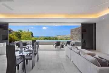 Modern living room and dining area with expansive outdoor view