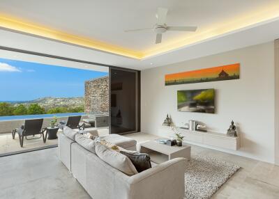 Modern living room with large sliding doors opening to a balcony with a scenic view