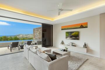 Modern living room with large sliding doors opening to a balcony with a scenic view