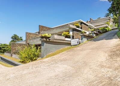 Modern multi-level house exterior with driveway