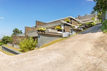 Modern multi-level house exterior with driveway