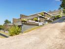 Modern multi-level house exterior with driveway