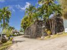 Driveway with lush greenery and modern stone wall