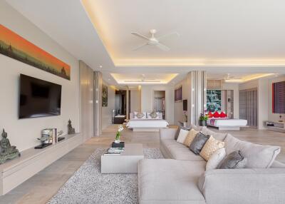 Modern living room with gray sofa, wall-mounted TV, and contemporary decor