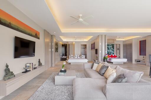 Modern living room with gray sofa, wall-mounted TV, and contemporary decor