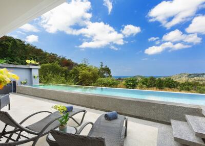 Modern outdoor patio with infinity pool and scenic view