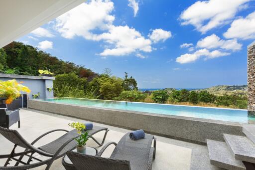 Modern outdoor patio with infinity pool and scenic view