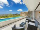 Outdoor area with swimming pool and lounge chairs, overlooking scenic hills