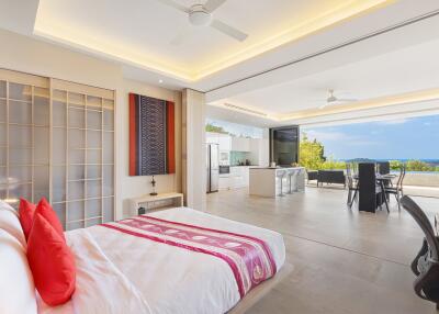 Modern and spacious bedroom with open living area and ocean view