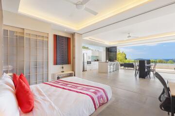 Modern and spacious bedroom with open living area and ocean view