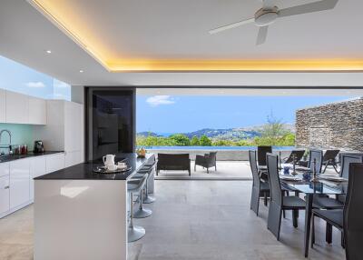 Modern open-plan kitchen and dining area with a scenic outdoor view