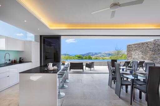 Modern open-plan kitchen and dining area with a scenic outdoor view