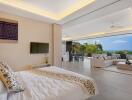 Spacious open-plan living area with bedroom, lounge, dining area, and ocean view.