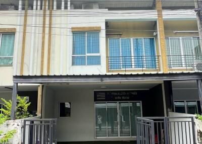 Two-story residential building with a front yard