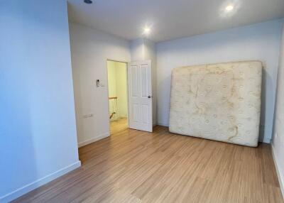 Spacious Bedroom with Light Wood Flooring and Recessed Lighting