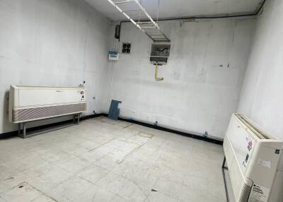 Utility room with white walls and air conditioning units