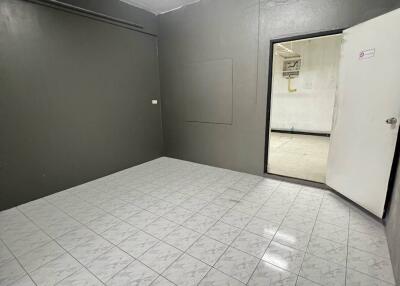 Empty room with tiled floor and white door