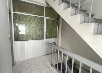 Staircase and corridor area with tiled flooring