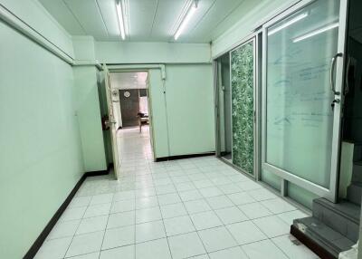 hallway with tiled floor and sliding glass doors