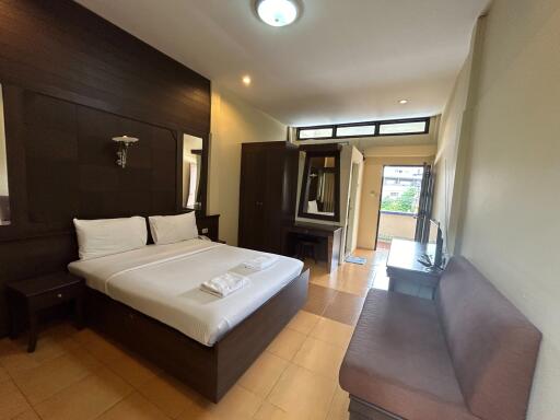 Modern and spacious bedroom with double bed and seating area