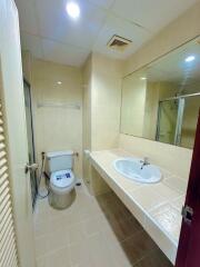 Modern bathroom with sink, toilet, and shower