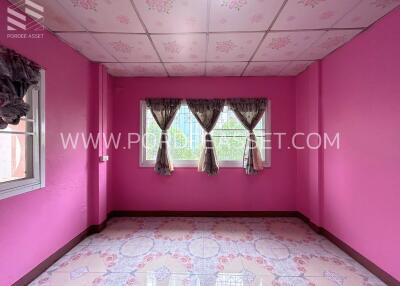 Bedroom with pink walls and floral curtains