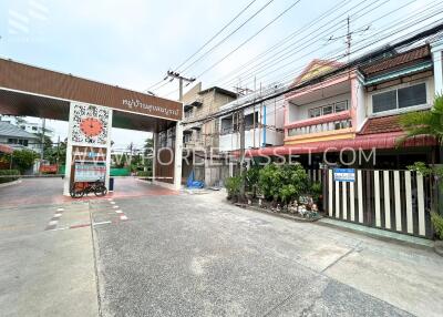 Entrance view of residential area with houses and gate