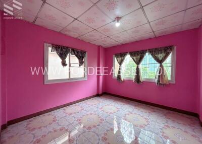 Bright room with pink walls and multiple windows