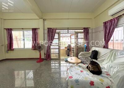 Living room with sofa, curtains, and large windows