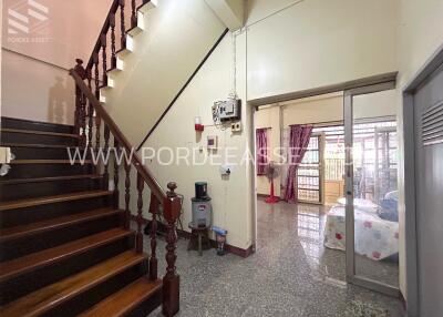 Living area with staircase and adjoining bedroom