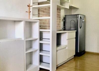 Modern kitchen with white cabinets and a stainless steel refrigerator