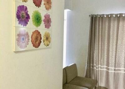 Living room with floral wall art and seating area