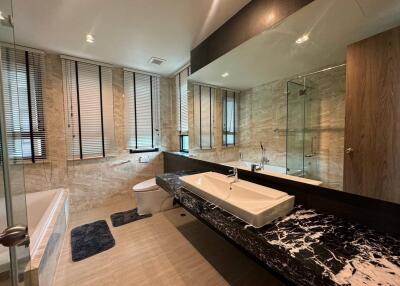 Modern bathroom with marble countertop and large walk-in shower